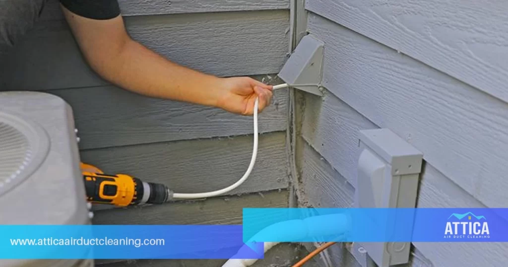 An image of a technician from Attica providing professional dryer vent cleaning services.