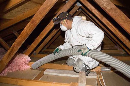 An image shows a technician from Attica providing insulation removal services. 