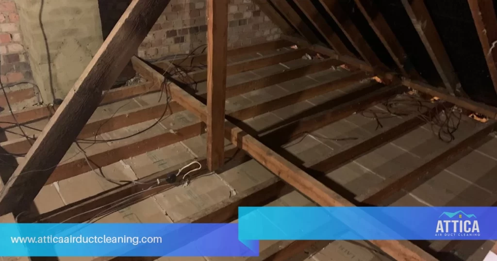 Professional insulation removal services show the inside of an attic without insulation.