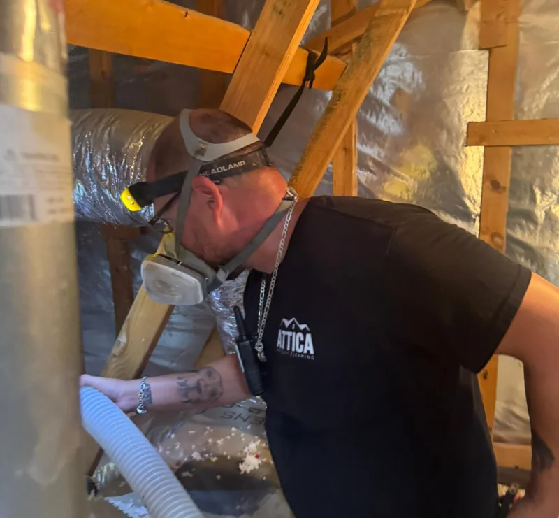 Attica professional installing insulation inside an attic.