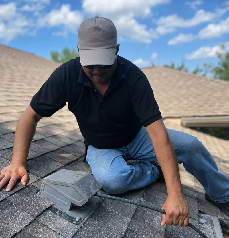 Attica Air Duct Cleaning technician inspecting and servicing a rooftop dryer vent.