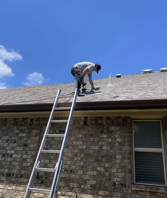 Attica Air Duct Cleaning technician accessing a rooftop dryer vent for professional cleaning.